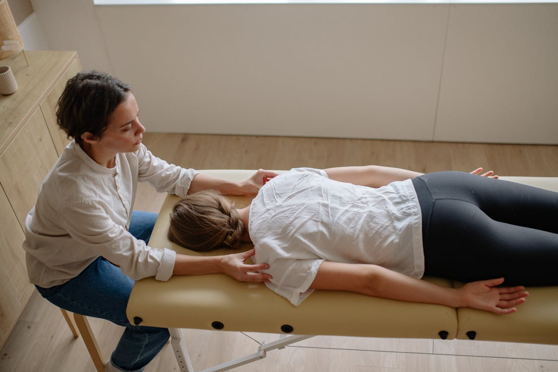 Therapist performing chiropractic adjustment indoors on a treatment table